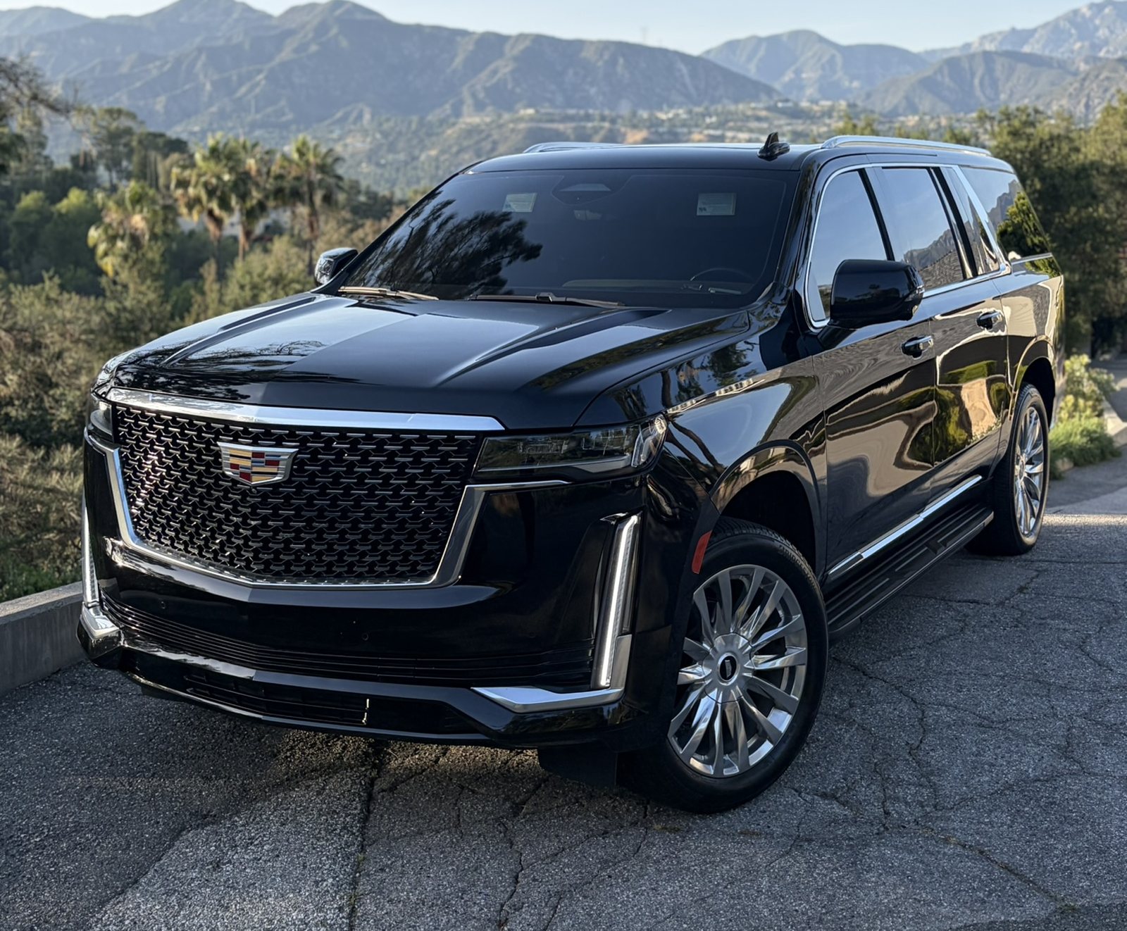 Black Cadillac Escalade ESV on a Los Angeles hillside drive